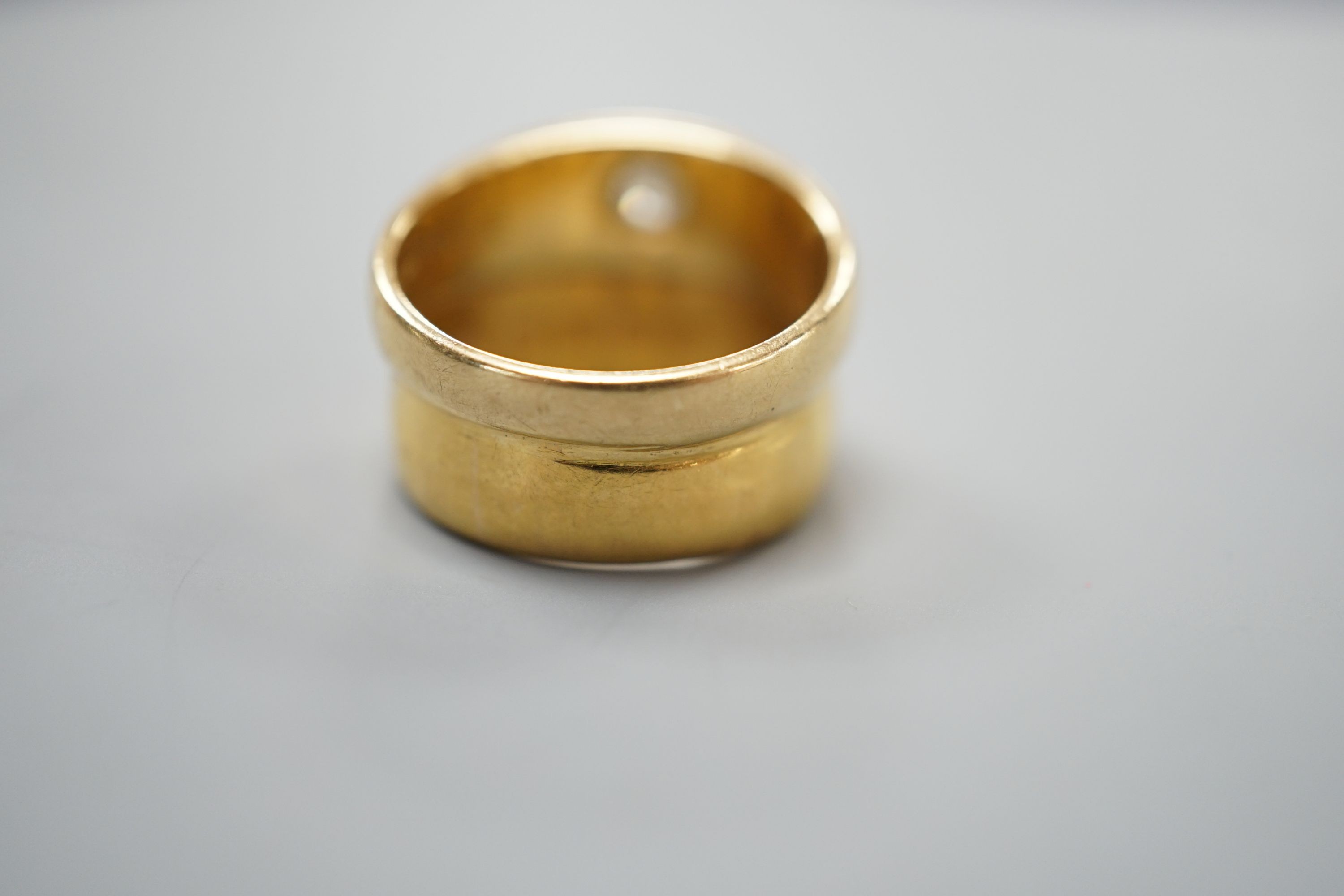 A 22ct gold band, welded to an 18ct gold and diamond set band, size L, gross weight 8.3 grams.